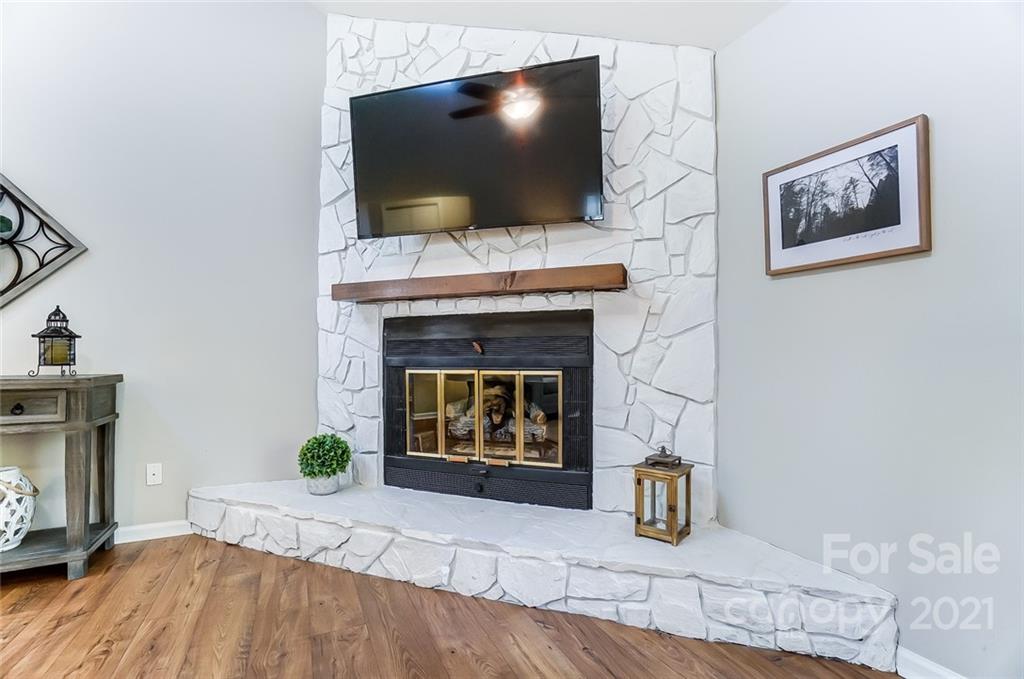 31016 Executive Point, Unit 15 Tega Cay, SC 29708 - Photo 6 of 35 a living room with furniture and a flat screen tv