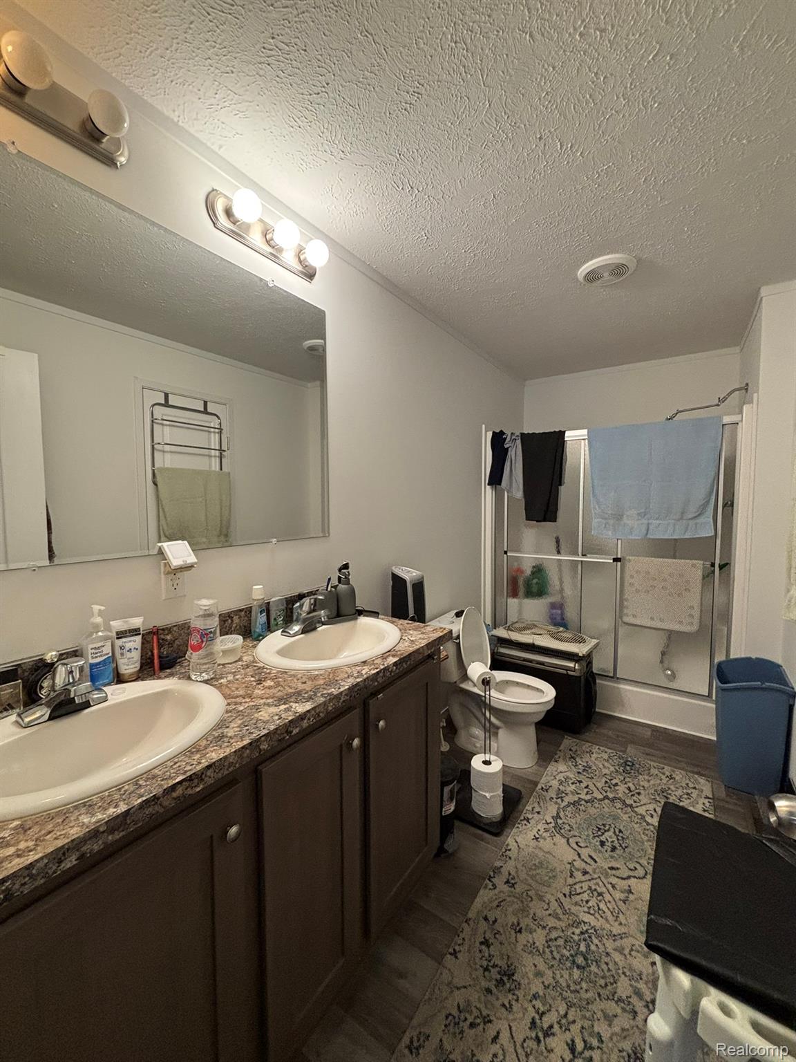 4101 South Sheridan Road Lennon, MI 48449 - Photo 11 of 20 Double vanity featuring two oval sinks and a patterned countertop