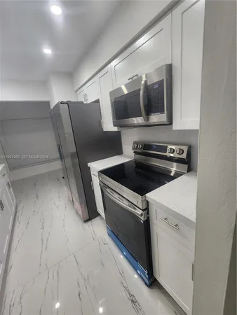 a view of kitchen with a sink and a stove top oven