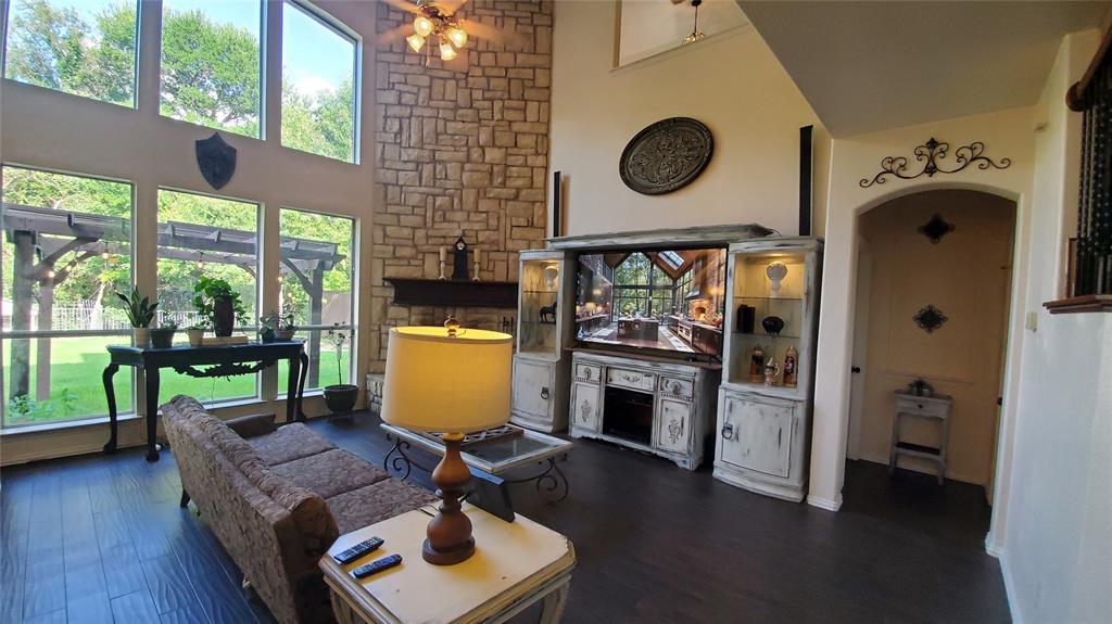3416 Ridge Lily Lane McKinney, TX 75071 - Photo 6 of 32 Living area with high vaulted ceiling, plenty of natural light, wood finished floors, a ceiling fan, and arched walkways