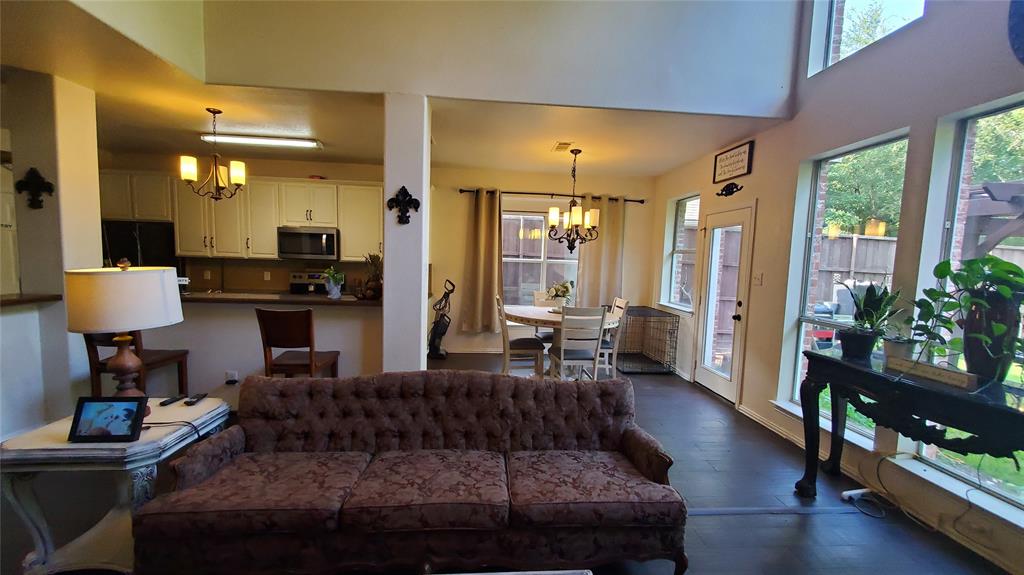 3416 Ridge Lily Lane McKinney, TX 75071 - Photo 8 of 32 Living room with a chandelier and dark wood-style flooring