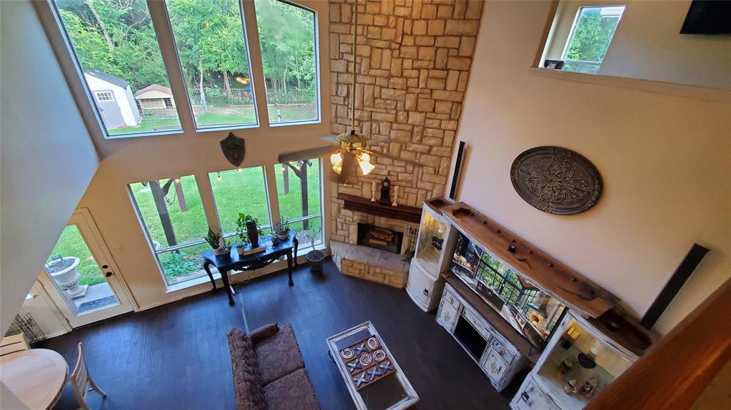 3416 Ridge Lily Lane McKinney, TX 75071 - Photo 9 of 32 Living room with a fireplace, a high ceiling, plenty of natural light, dark wood finished floors, and ceiling fan