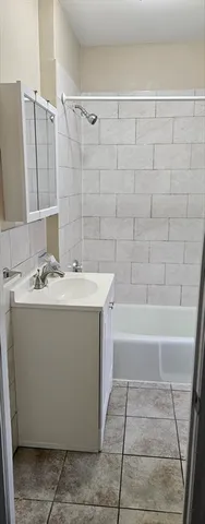 a bathroom with a sink a mirror and a bathtub