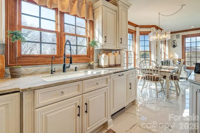 a kitchen with sink cabinets and dining table