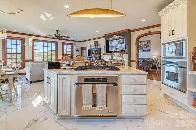 a kitchen with stainless steel appliances granite countertop a stove and cabinets