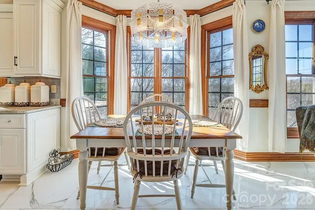 a view of a dining room with furniture and chandelier