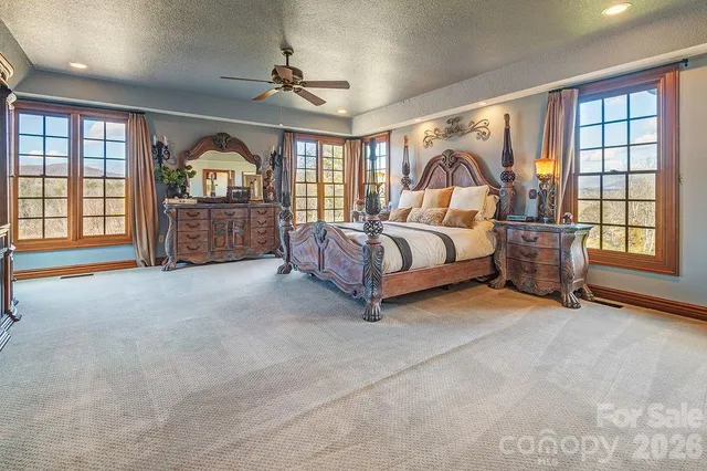 a bedroom with a large bed and a window