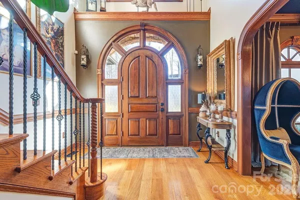 a view of staircase with wooden floor and a large window