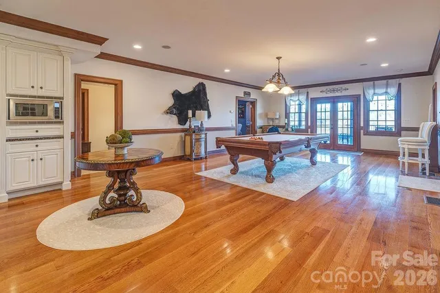 a living room with furniture a fireplace and a chandelier