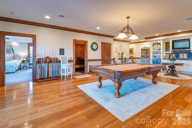 a living room with furniture a table and large windows