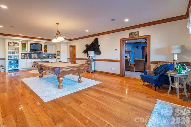 a living room with fireplace furniture and a wooden floor