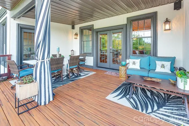 a view of a patio with table and chairs wooden floor