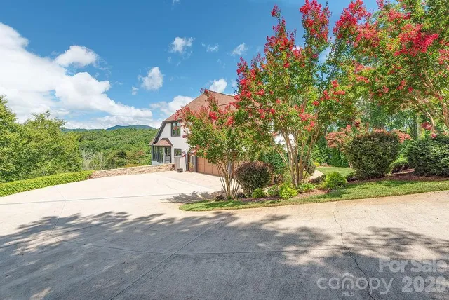 a view of a house with a yard and garage