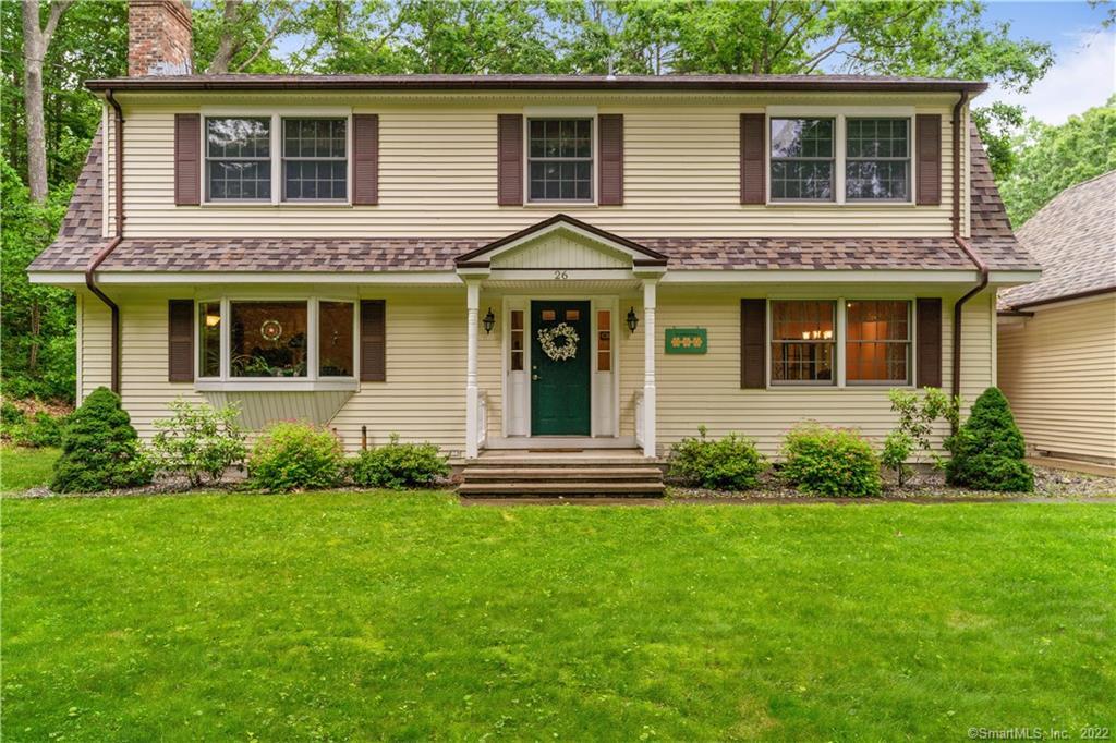 a view of a house with a yard and plants