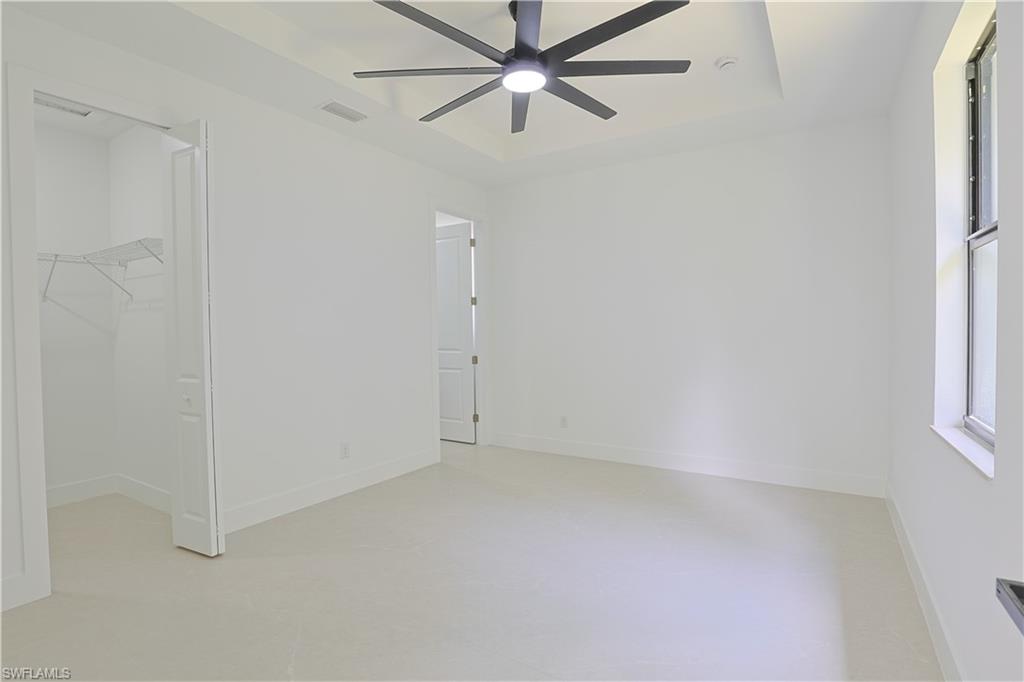 613-615 West 12th Street Lehigh Acres, FL 33972 - Photo 12 of 32 an empty room with a window and a ceiling fan