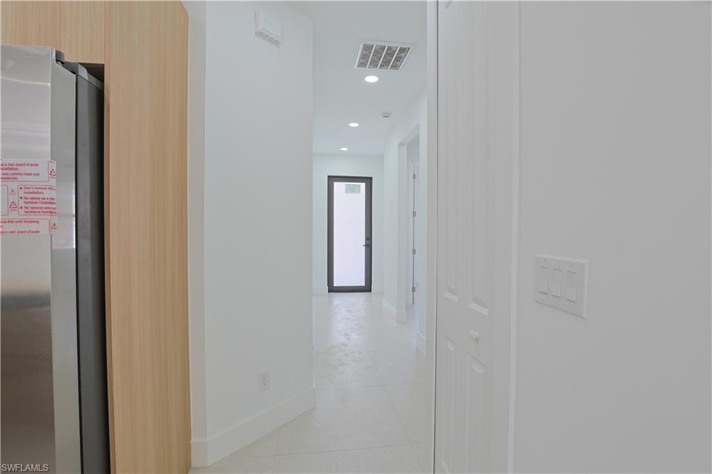 613-615 West 12th Street Lehigh Acres, FL 33972 - Photo 17 of 32 a view of a hallway with closet and mirror