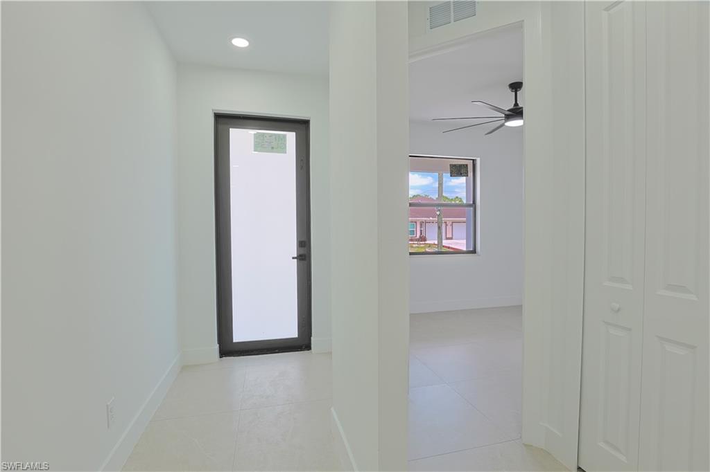 613-615 West 12th Street Lehigh Acres, FL 33972 - Photo 18 of 32 an empty room with windows and closet