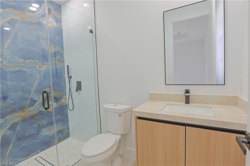 613-615 West 12th Street Lehigh Acres, FL 33972 - Photo 21 of 32 a bathroom with a sink a toilet and shower
