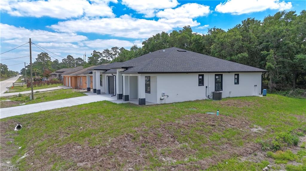 613-615 West 12th Street Lehigh Acres, FL 33972 - Photo 28 of 32 a house view with a garden space