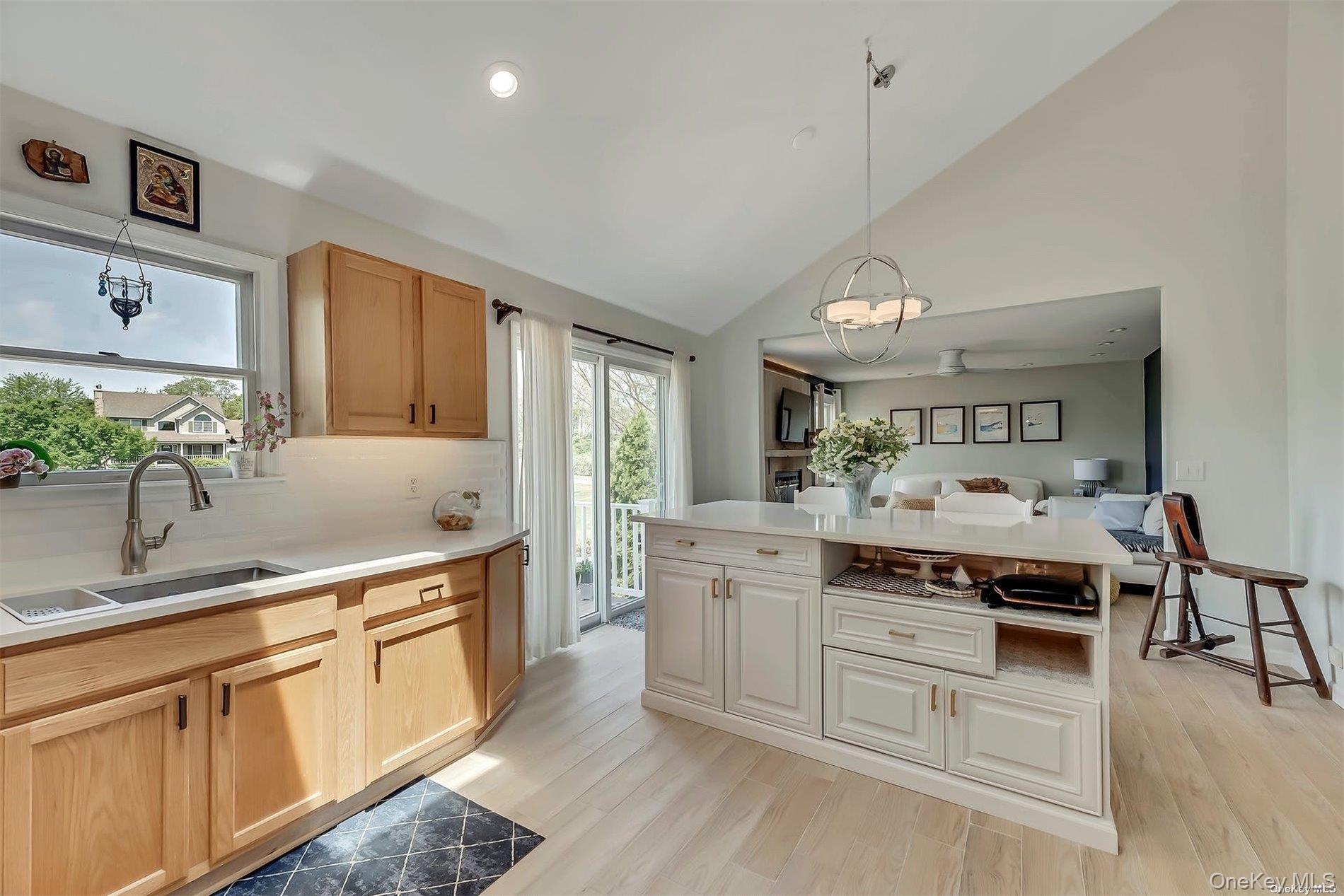 170 Vineyard Way Riverhead, NY 11901 - Photo 6 of 11 a kitchen with stainless steel appliances granite countertop a stove a sink dishwasher and white cabinets with wooden floor