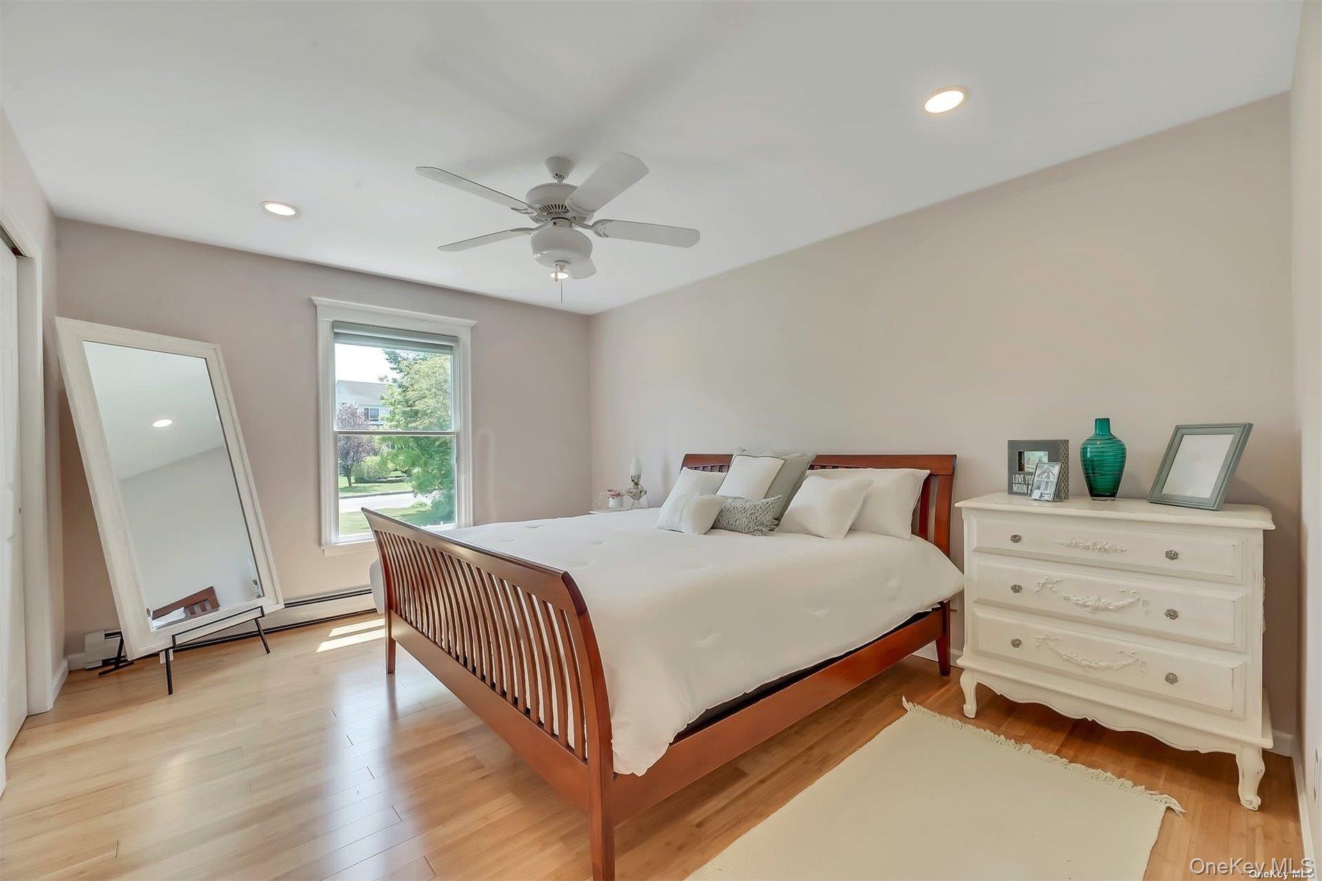 170 Vineyard Way Riverhead, NY 11901 - Photo 7 of 11 a bedroom with a bed and a window