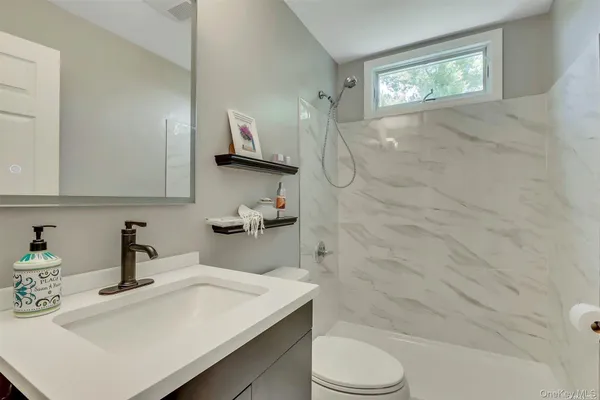 a view of a park with big yard and a large tree