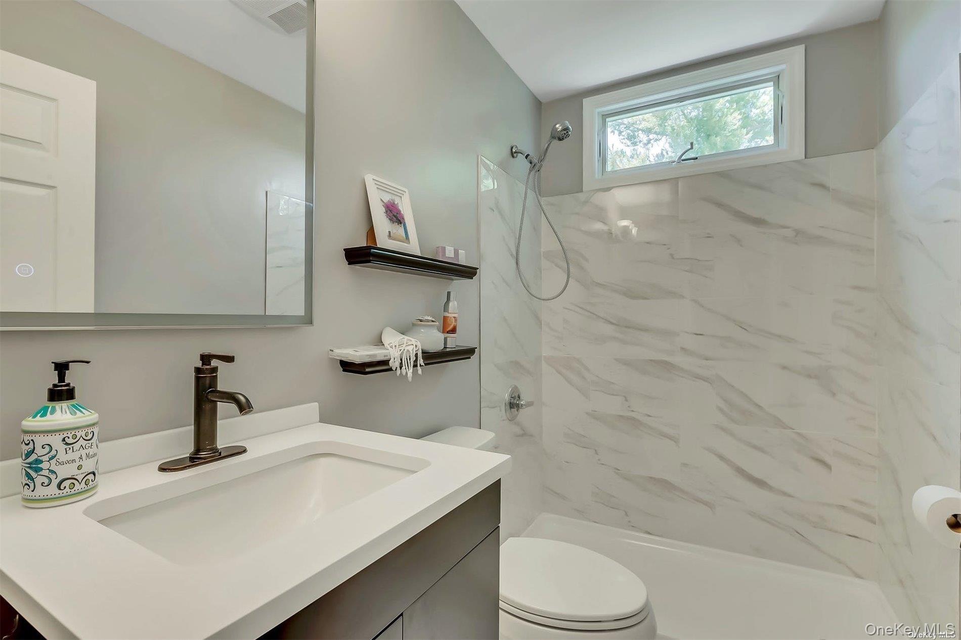 170 Vineyard Way Riverhead, NY 11901 - Photo 10 of 11 a bathroom with a sink a toilet and shower