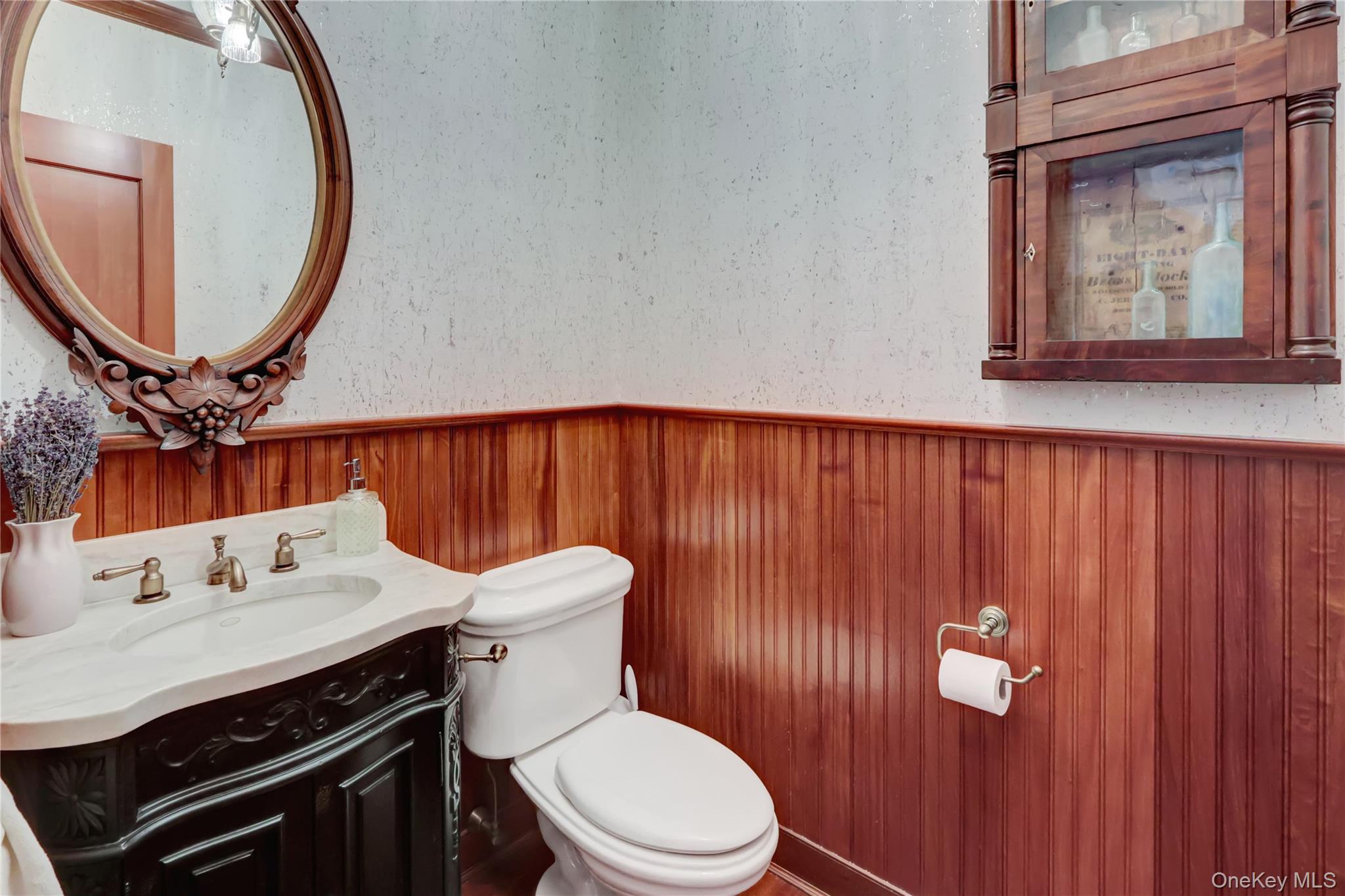 63 Dyke Road Setauket, NY 11733 - Photo 15 of 49 Half bath featuring vanity and a wainscoted wall