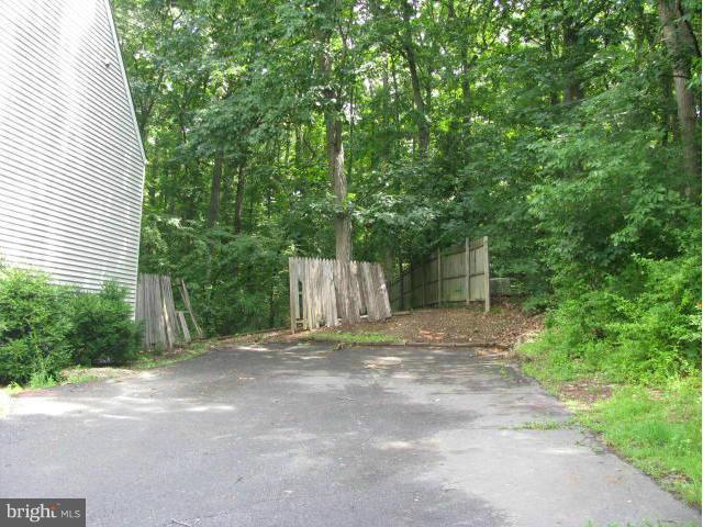 17981 Possum Point Road Dumfries, VA 22026 - Photo 27 of 27 a view of a house with a yard and garage