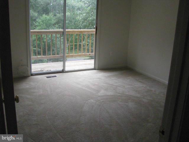 17981 Possum Point Road Dumfries, VA 22026 - Photo 6 of 27 a view of an empty room with a sliding door