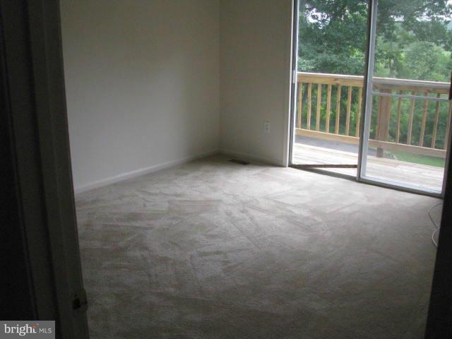 17981 Possum Point Road Dumfries, VA 22026 - Photo 7 of 27 a view of an empty room with a balcony