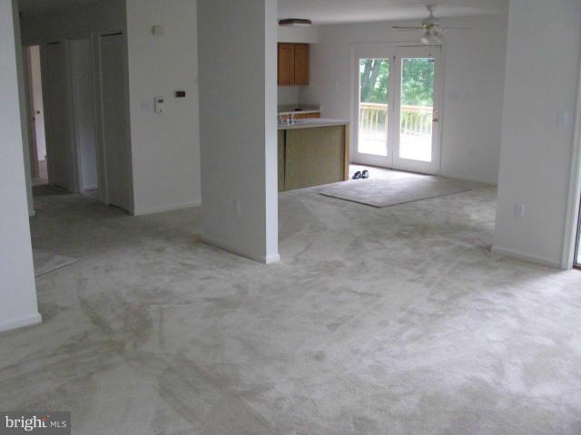 17981 Possum Point Road Dumfries, VA 22026 - Photo 9 of 27 an empty room with a fireplace and a window