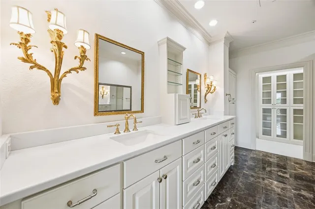 a bathroom with double vanity sink a two mirror a window and glass door