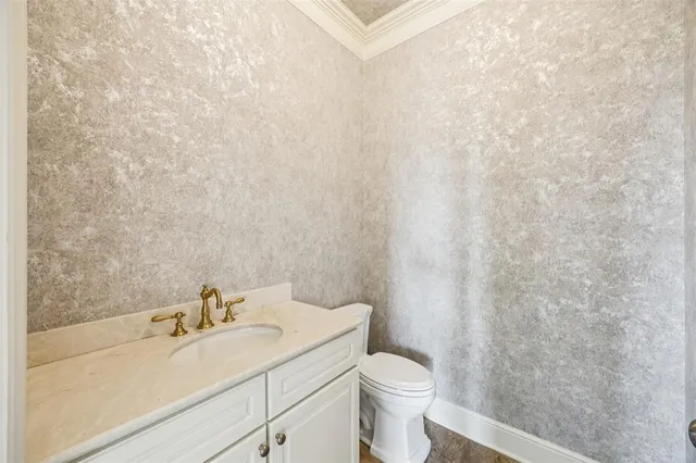 a bathroom with a sink a toilet and vanity
