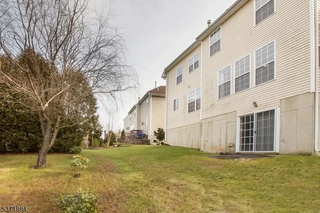 a backyard of apartments with large trees