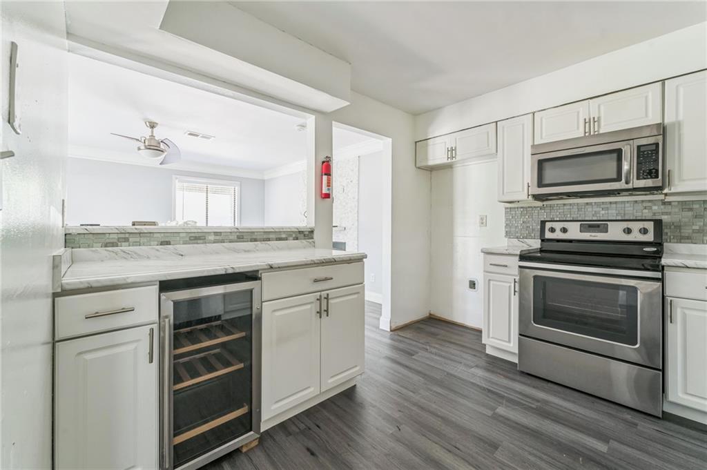 18 Quail Run, Unit A Decatur, GA 30035 - Photo 11 of 28 a kitchen with stainless steel appliances granite countertop a stove and a refrigerator