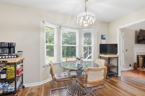 a living room with furniture a flat screen tv and a large window