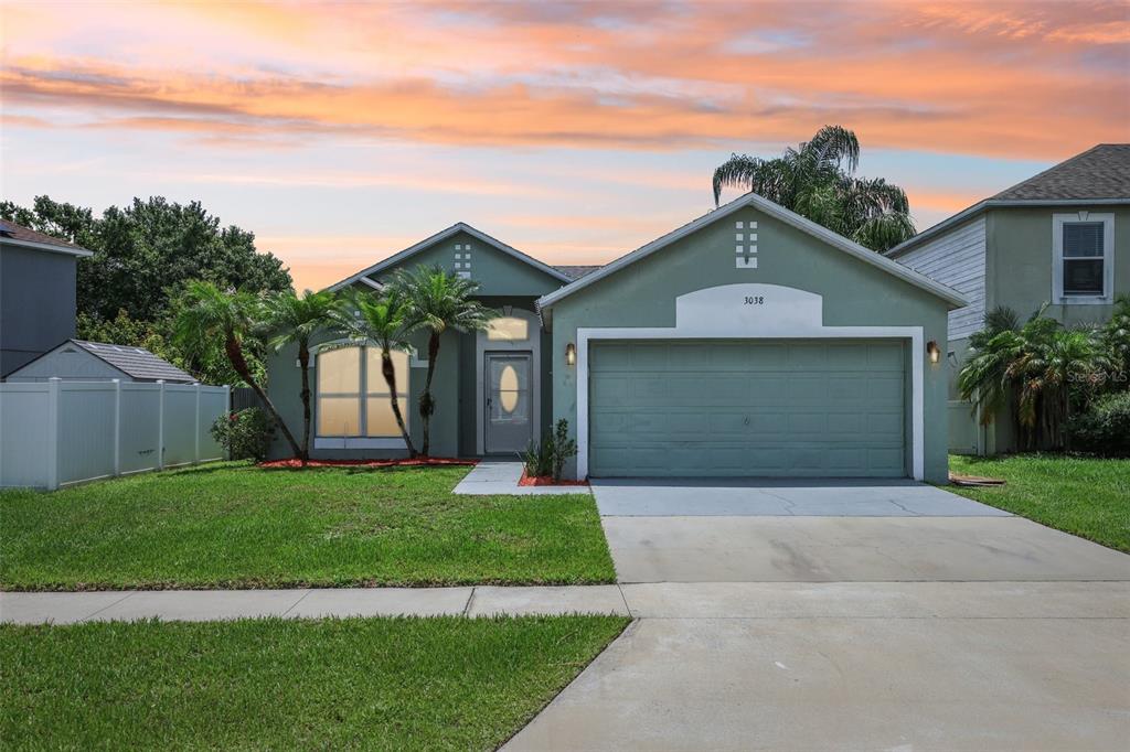 a front view of a house with a yard and garage