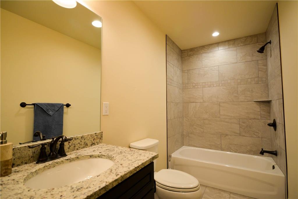 764 Independence Road, Unit 1B Keystone, CO 80435 - Photo 6 of 25 a bathroom with a granite countertop sink toilet and shower