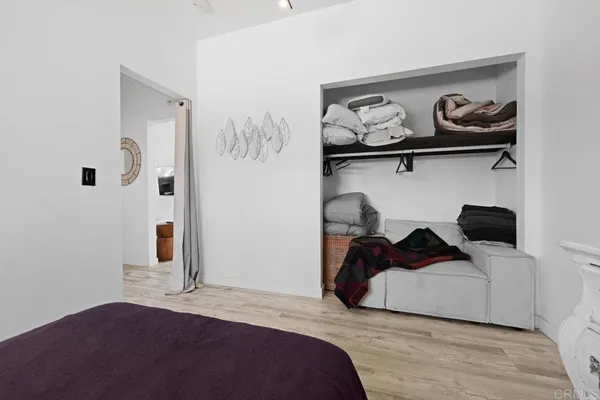 a bedroom with a bed and cabinets