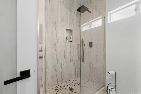 a bathroom with a shower and a shower