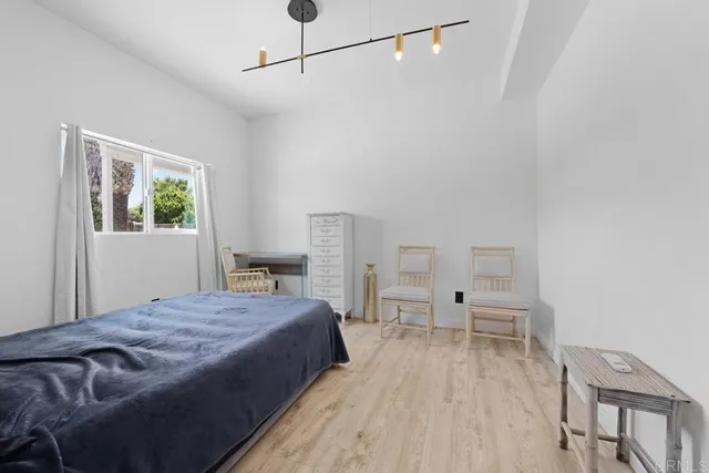 a spacious bedroom with a bed and a table