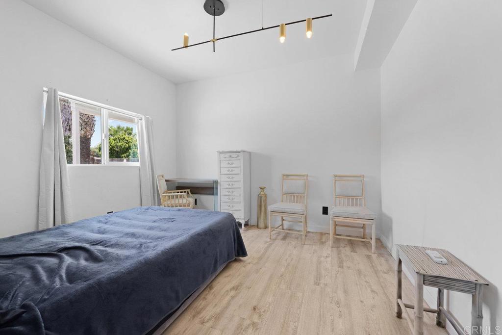 12953 Carriage Road Poway, CA 92064 - Photo 16 of 42 a spacious bedroom with a bed and a table