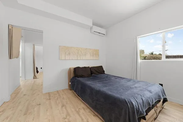 a bedroom with a bed and window