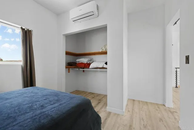 a bedroom with a bed and a window