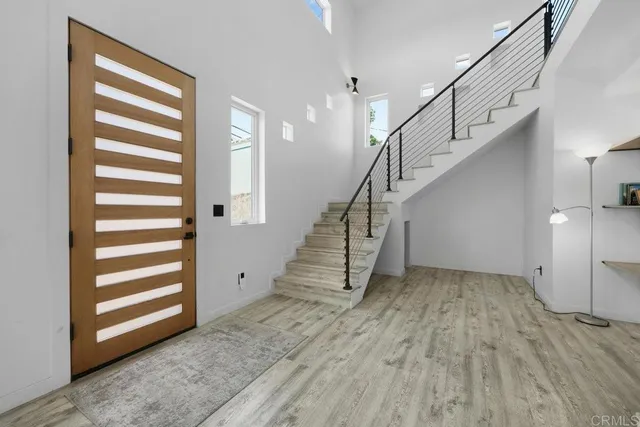 a view of entryway and hall with wooden floor