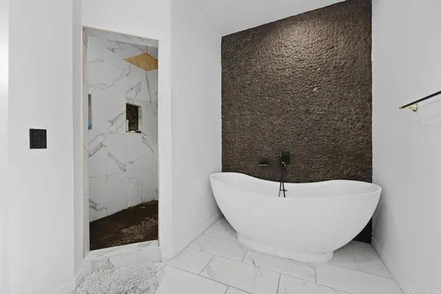 a bathroom with a bathtub and shower
