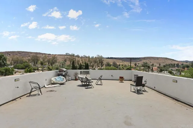 a view of a terrace with couches and sky view