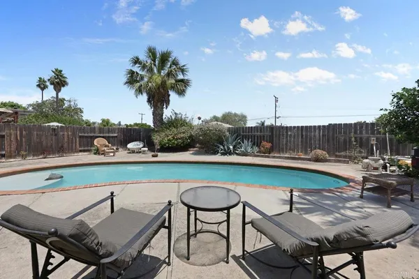 a view of a chairs and table in patio