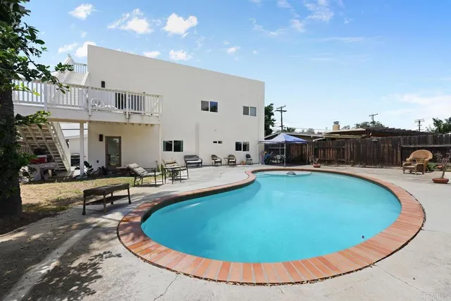 a view of a swimming pool with outdoor seating